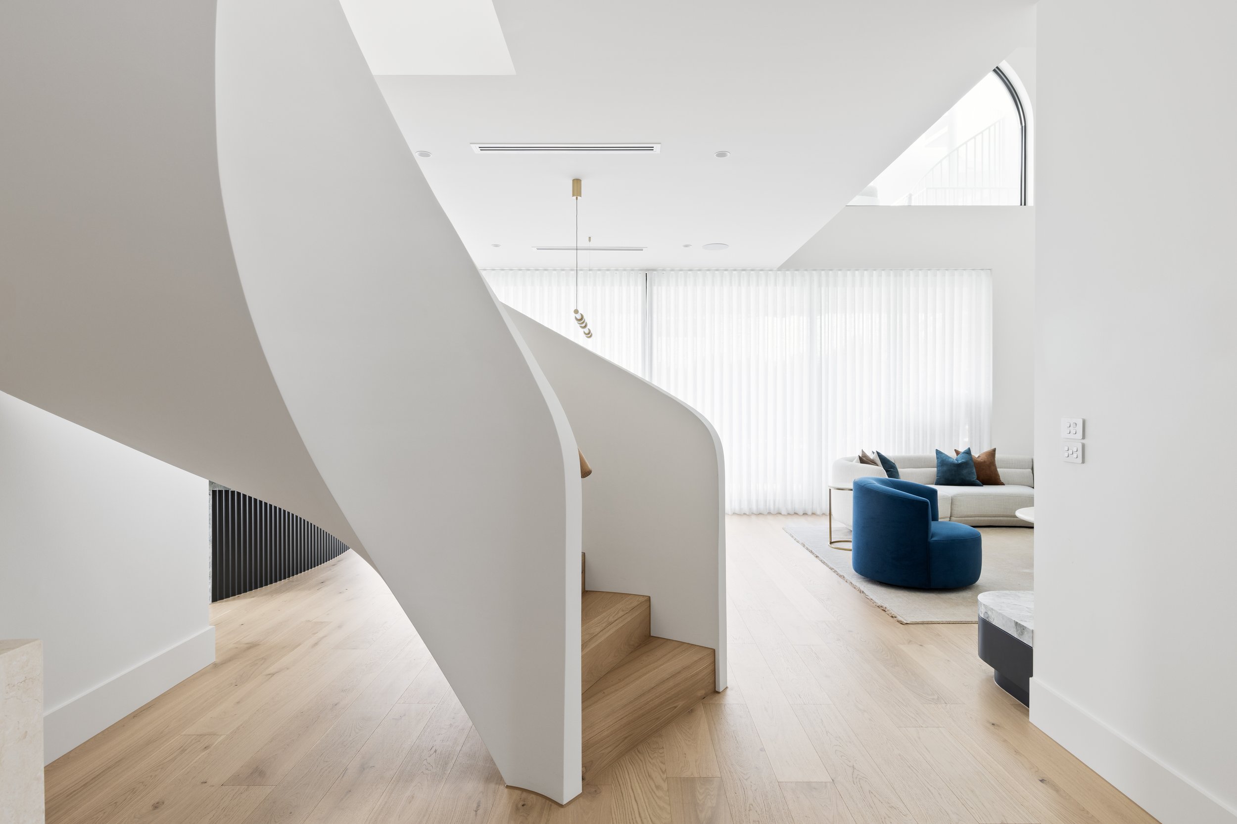 AJL Studio interior design project, curved staircase and open living